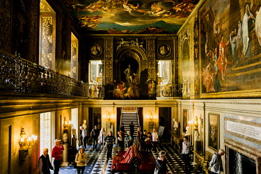 Visitors inside Chatsworth House. The mural on ceiling and wall by French artist, Louis Laguerre (1663-1721).