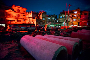Concrete pipes lie on the ground at a construction site on the outskirts of Kathmandu. While a ring road is supposed to run around the periphery of the city, construction has now spilled out beyond th...