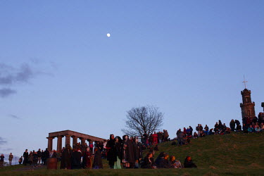 People gather near the National and Nelson Monuments on Carlton Hill in Edinburgh to celebrate hte annual Beltane Fire Festival.  The Beltane Festival is an annual event when winter is purged by fire...