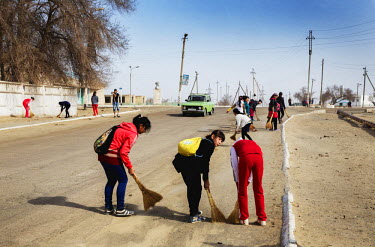 Schoolchildren sweep the streets as a community service in Muynak, a former Soviet fishing port on the Aral Sea.