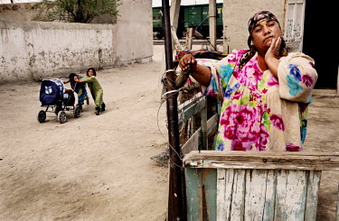 A woman from a small community of gypsies living in the suburbs of Bukhara in a poor district near a railway crossing.