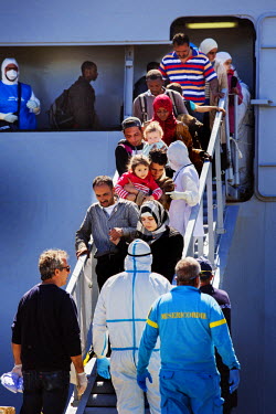 Migrants, rescued by the Italian navy from a boat in the Mediterranean Sea, disembark after reaching Sicily. The 447 migrants, who had sailed from Egypt, were from different countries, included Syria,...
