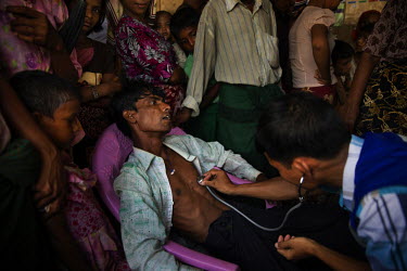 A Rohingya man who had an untreated hernia and has been unable to eat properly for weeks is examined by a Ministry of Health doctor who was part of a Ministry of Health 'Mobile Health Team' on a rare...