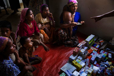 Patients, many suffering from malnutrition, wait to be given medicine, vitamin supplements and rehydration salts by unqualified volunteer healthcare workers in a temporary clinic. The facility, at an...