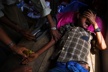 A Rohingya boy reacts to treatment for malnutrition in a temporary clinic supported by Muslim donors from Yangon (Rangoon) and staffed by unqualified volunteers at an IDP camp near Thet Kay Pyin in th...