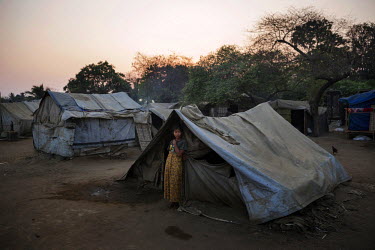 A Rohingya woman stands outside her tent in the Thae Chaung IDP camp in the Rohingya segregated area north of Sittwe.  The Rohingya are a Muslim people who have significant communities in several Asia...