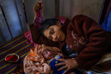 Lay Lay Win, 28, lies beside her new born baby soon after giving birth in Dapaing Health Clinic in Dapaing village in a segregated area north of Sittwe. The Myanmar government only provides one Minist...