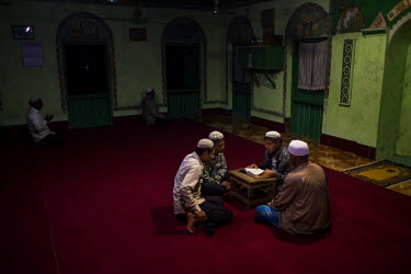 Rohingya men read the Koran and prey in a mosque in Dapaing village in a segregated area north of Sittwe. The Rohingya are a Muslim people who have significant communities in several Asian countries....