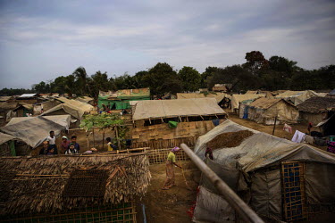 A Rohingya woman sweeps outside her tent in the Thae Chaung Rohingya IDP camp, established after violent clashes between Muslim Rohingya and Budhhist Rakihine extremists. Its residents are prevented f...