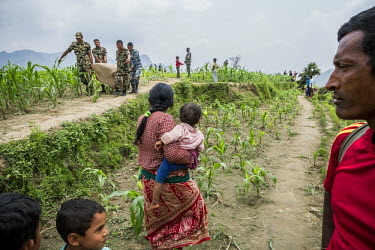 Nepali Army soldiers carry food aid, that was air-dropped to Saurpani area by the Indian Military. Being close to the epicentre and sited on a steep hillside, Saurpani was extremely hard hit by the 25...