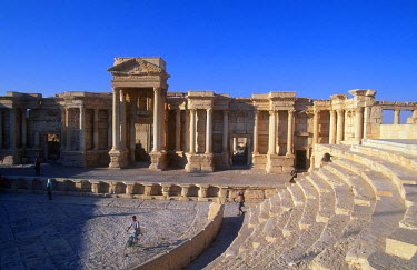 The restored Roman theatre in the ancient ruins of Palmyra. Palmyra (or Tadmor in Arabic) dates back to the Neolithic period and was first mentioned in the second millennium BC as a caravan stop. It l...