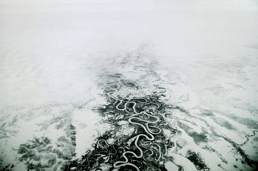 A waterway snakes its way through the frozen tundra below seen from an airplane. Norilsk, some 400 kms above the arctic circle, is not accessible by road or railway. It can only be accessed by waterwa...