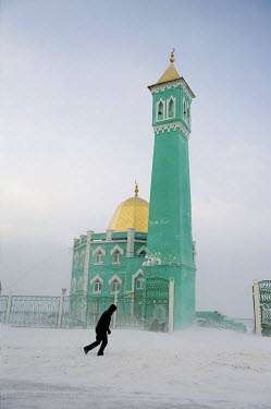 A man walks past a mosque in Norilsk which provides a place of prayer for immigrants from Azerbaijan, other Muslim republics in the Caucasus, the republic of Bashkortostan in Russia and other Central...