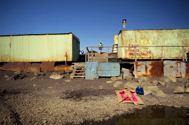A woman sunbathes on a desolate piece of shore near a lake in the city of Norilsk. The city has very few green spaces and people need to travel at least 30 kms to get to proper nature.  The city of No...