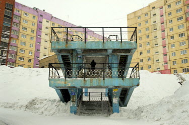 A man walks down a staircase next ao high rise residential builings in the city of Norilsk.  The city of Norilsk, in the far north of Russia's Krasnoyarsk region, was founded in the 1920s and today ha...