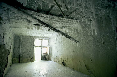 The interior of an abaondoned multi storey building in Norilsk covered in ice.  The city is facing an infrastructural crisis since most of the buildings were built on pylons driven into permafrost. As...