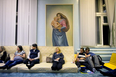 Women attend a pre-natal class in a room with a large painting of the Virgin Mary on the wall. Despite the harsh climate conditions in Norilsk and the environmental problems caused by industry the bir...