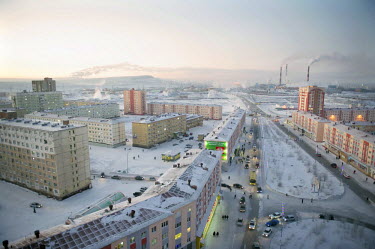 A view of central Norilsk on a cold day with traffic and pedestrians visible below.  The city of Norilsk, in the far north of Russia's Krasnoyarsk region, was founded in the 1920s and today has a popu...