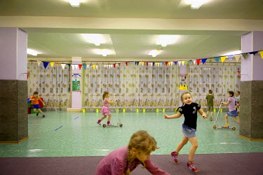 Children play and ride around on scooters in an indoor playground in Norilsk. In schools, outside temperature is measured regularly to determine whether it's safe for children to play outside. Sometim...