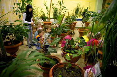 Children play amongst plant pots in an indoor playground in a kindergarten. In schools, outside temperature is measured regularly to determine whether it's safe for children to play outside. Sometimes...