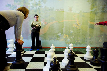 Children play a game of giant chess in an indoor playground. In schools, outside temperature is measured regularly to determine whether it's safe for children to play outside. Sometimes they have to s...