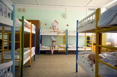 Children go to sleep in a day school during the day in the polar summer. The sun doesn't set for around 45 days which can make people disorientated and cause sleep disorders.  The city of Norilsk, in...