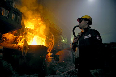 A worker breathes in clean air from a pipe while working in one of the smelters of Norilsk Nickel. The air in the smelters contains various noxious gases making it unsafe to breathe.  The city of Nori...