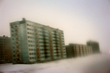 Rows of abandoned high rise residential buildings in Norilsk.  The city is facing an infrastructural crisis since most of the buildings were built on pylons driven into permafrost. As the top layer of...