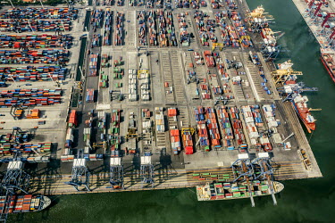 Shipping containers and ship-to-shore cranes in the Port of Jakarta, also known as Tanjung Priok Port. It is the largest Indonesian seaport with an annual traffic capacity of around 45 million tonnes...