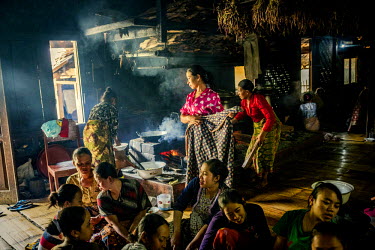 In the afternoon a group of women from the village are preparing food in the communal kitchen. One of the Adat traditions is that everyone is welcome at the Imah Gede, and it is the custom that there...