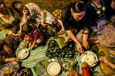In the communal kitchen of the village, women prepare foods specific to the Adat custom, performed monthly during the new moon, of paying respect for the gift of rice.
