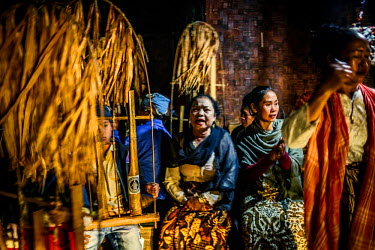 Villagers perform at night, singing and playing traditional bamboo musical instruments known as Angklung, during the lunar ceremony. The performance is a celebration and a way to give thanks for the b...