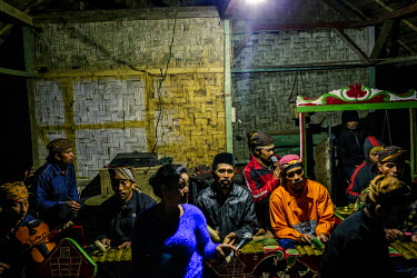 Villagers perform at night, singing and playing traditional bamboo musical instruments known as Angklung, during the lunar ceremony. The performance is a celebration and a way to give thanks for the b...