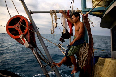 A Cambodian migrant fisherman looks out to sea from a Thai flagged fishing boat in Thai waters in The Gulf of Thailand.