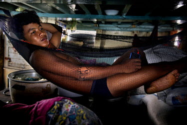 A Cambodian migrant fisherman rests in a makeshift hammock in cramped quarters on a Thai flagged fishing boat in Thai waters in The Gulf of Thailand.