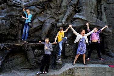 Children play on a statute of soldiers at the National Museum of the History of the Great Patriotic War (1941-1945). The sculptures depict the courageous defense of the Soviet border from the 1941 Ger...