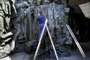 A man washes statues during preparations for celebrations of Victory Day over Fascism near the National Museum of the History of the Great Patriotic War (1941-1945). Sculptures depict the terrors of t...