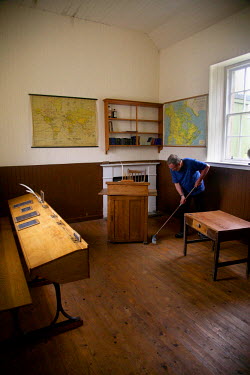 A volunteer cleans a school room on Hirta, the largest island in the St Kilda archipelago. People come to work in three summer groups for two weeks at a time. Tasks include stone work on walls and cle...