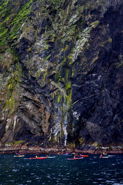 Sea kayakers beneath the largest sea cliffs in the UK at Conachair on Hirta, the largest island in the St Kilda archipeleago. The archipelago lies, isolated, in the Atlantic 40 miles off the western i...