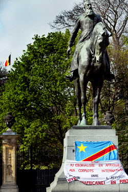 A banner hung from the pedestal of a statue of king Leopold II denounces 'colonisation of Africa and international conspiracies'. The statue is near the European Parliament where an EU-Africa trade su...
