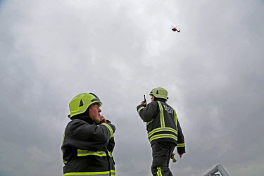 Fire crew prepare for a landing by London's Air Ambulance, also known as London HEMS (Helicopter Emergency Medical Service), a British registered charity that operates an air medical service dedicated...