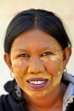 A  Bugis ('sea gypsy') woman, her face coated in traditional cooling and protecting paste, at Wuring village, a stilted Bugis settlement on the coast close to Maumere.