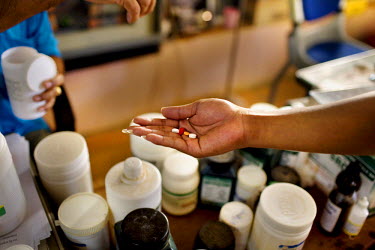 A recovering drug addict takes required medication,usually a type of benedryl (antihistamine), a B-12 vitamin, a charcoal tablet, which absorbs substances in the stomach and intestines, and another ta...