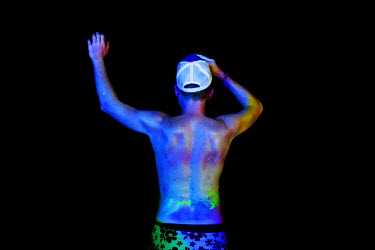 A man during a full moon party. The full moon party on Haad Rin Beach on the island of Ko Pha Ngan in Thailand attracts about 30 000 partying backpackers and other tourists every synodic month.