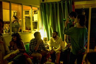 Young aspiring actors, musicians and other people from the Bombay film industry at a house party in an apartment in Mumbai.