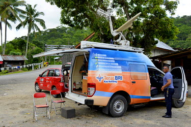 A mobile unit of the BRI (Bank Rakyat Indonesia), one of the most popular banks across the nation, sets up in a rural location, using its satelite communications to offer ATM services to villagers who...