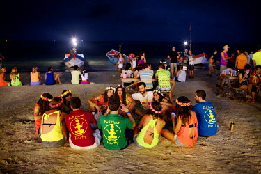 A group of young people, wearing their 'Full Moon Party' t-shirts, gathered on the beach durinn the party. Allegedly started in the early 1980s and attended by a handful of Western travellers and curi...