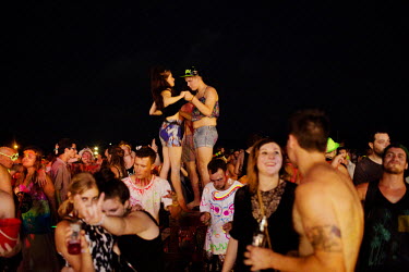 A group dancing on a table on the beach. The full moon party on Haad Rin Beach on the island of Ko Pha Ngan in Thailand attracts about 30 000 partying backpackers and other tourists every synodic mont...