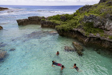 People swim in the Limu Pools in the northern part of Niue. Limu Pools is the only place on the island where people can swim safely as Niue doesn't have any sandy beaches.  The tiny island of Niue in...