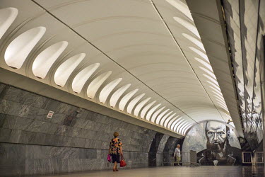 A passenger walks through a tunnel towards a mural of the great writer Fyodor Dostoevsky at at Dostoevskaya Metro Station. Opened in 2010, the station features shadowy figures from his classic novels.